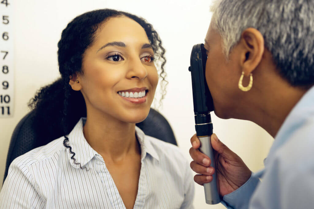 Optometrist examining her patient's eyesight