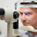 The ophthalmologist opened the patient's eye using laser treatment to correct vision problems.