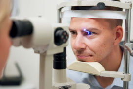 The ophthalmologist opened the patient's eye using laser treatment to correct vision problems.