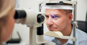 The ophthalmologist opened the patient's eye using laser treatment to correct vision problems.